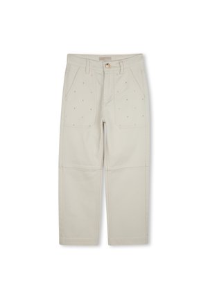 Pantalons en coton beige avec des coutures visibles, deux poches avant et une fermeture à bouton. Présente des petits points décoratifs sur le tissu.