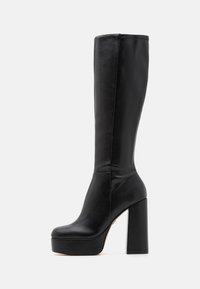 Black knee-high boots made of smooth leather with a textured finish, featuring a high block heel and a round toe design.