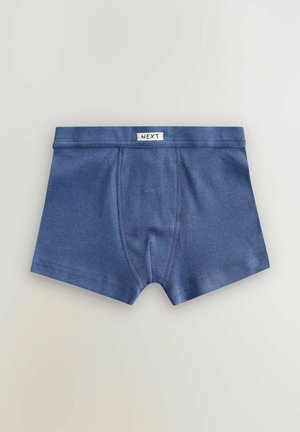 Blå ribbede bomulds drenge boksershorts med syede paneler og "NEXT" mærket på taljen, lagt fladt på en lys baggrund.