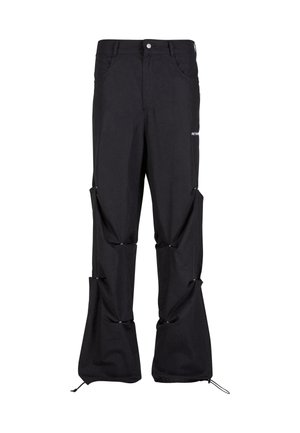 Black cargo pants with detachable sections, featuring buttons and drawstrings at the hem. Made of durable fabric with a relaxed fit design.