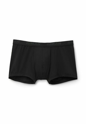 Boxer cortos negros hechos de una tela suave. La cinturilla elástica presenta una sutil marca en un tono más oscuro. Diseño clásico de tronco sin patrones.