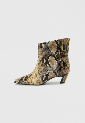 Ankle-high boot with a low heel and beige, black, and brown snakeskin pattern on a plain light background.