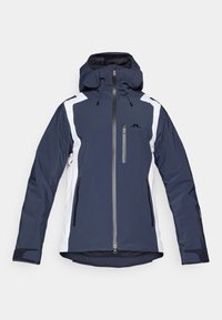 Sötétkék sídzseki fehér részletekkel, kapucnival, elöl cipzárral, két oldalsó zsebbel és állítható mandzsettákkal. Tartós anyagból készült.