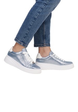 Metallic blue sneakers with white laces, textured upper, and a thick white platform sole. Worn with cropped denim jeans.