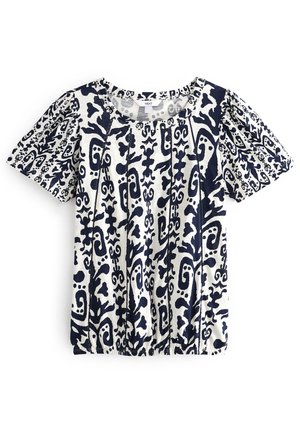 Chemisier blanc à manches courtes avec imprimé tribal abstrait bleu marine, col rond, ourlet froncé et manches légèrement bouffantes.