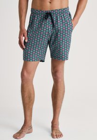 Zwemshorts van lichtgewicht stof met een turquoise achtergrond en een geometrisch patroon in roze en paars, elastische tailleband met een trekkoord.