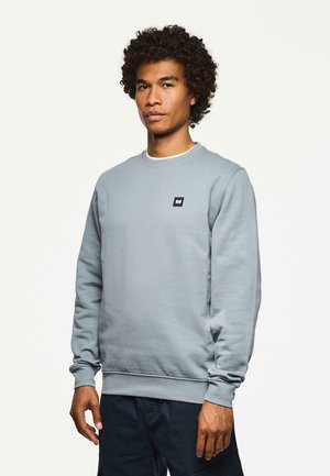 Light gray sweatshirt made of cotton blend, featuring a crew neck, ribbed cuffs, and a small black label on the chest.