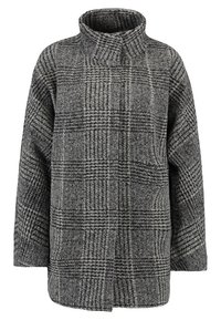 Grå rutig kappa med hög krage, breda ärmar och avslappnad passform. Tillverkad av en strukturerad ullblandning med svartvita rutmönster.