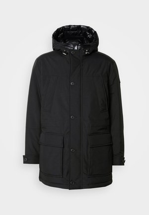 Black parka jacket with a hood, featuring multiple front pockets, a button closure, and a textured exterior. Lined with shiny material.