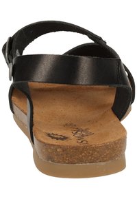 Sandalo in pelle nera con soletta in sughero, dotato di un cinturino posteriore e una suola texturizzata. Design semplice con dettaglio in metallo regolabile.
