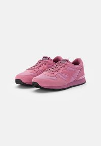 Pink athletic shoes made of suede and mesh with a textured finish, flat laces, and black rubber sole. Features a multi-panel design.