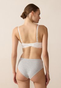 White lace-trimmed bra with adjustable straps and a gray cotton high-waisted brief. Smooth texture with a simple design.