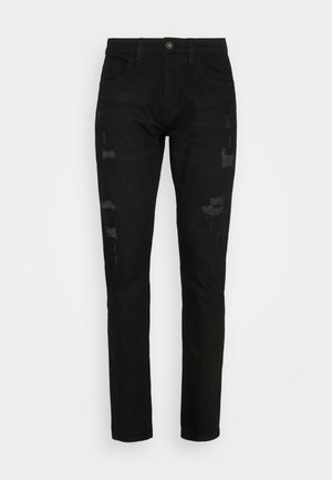 Jeans de denim negro con un corte ajustado, que presentan detalles desgastados y un leve desvanecimiento. Diseño de cinco bolsillos con cierre de botón metálico.