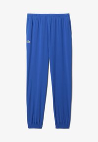 Pantaloni sportivi blu con elastico in vita e sui polsini, tasche laterali e un piccolo logo di coccodrillo verde sulla coscia sinistra.