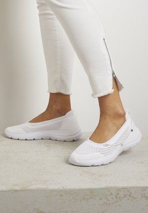 White slip-on shoes with a mesh upper, textured design, and cushioned sole. Features small metal accents for added detail. Paired with white pants.