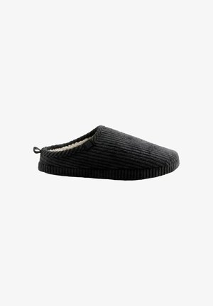Black corduroy slipper with a textured surface, soft lining, and a loop tab at the heel for easy wear. Features a minimalistic design.