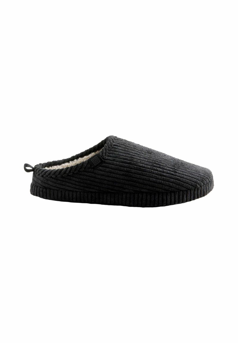 Black corduroy slipper with a textured surface, soft lining, and a loop tab at the heel for easy wear. Features a minimalistic design.