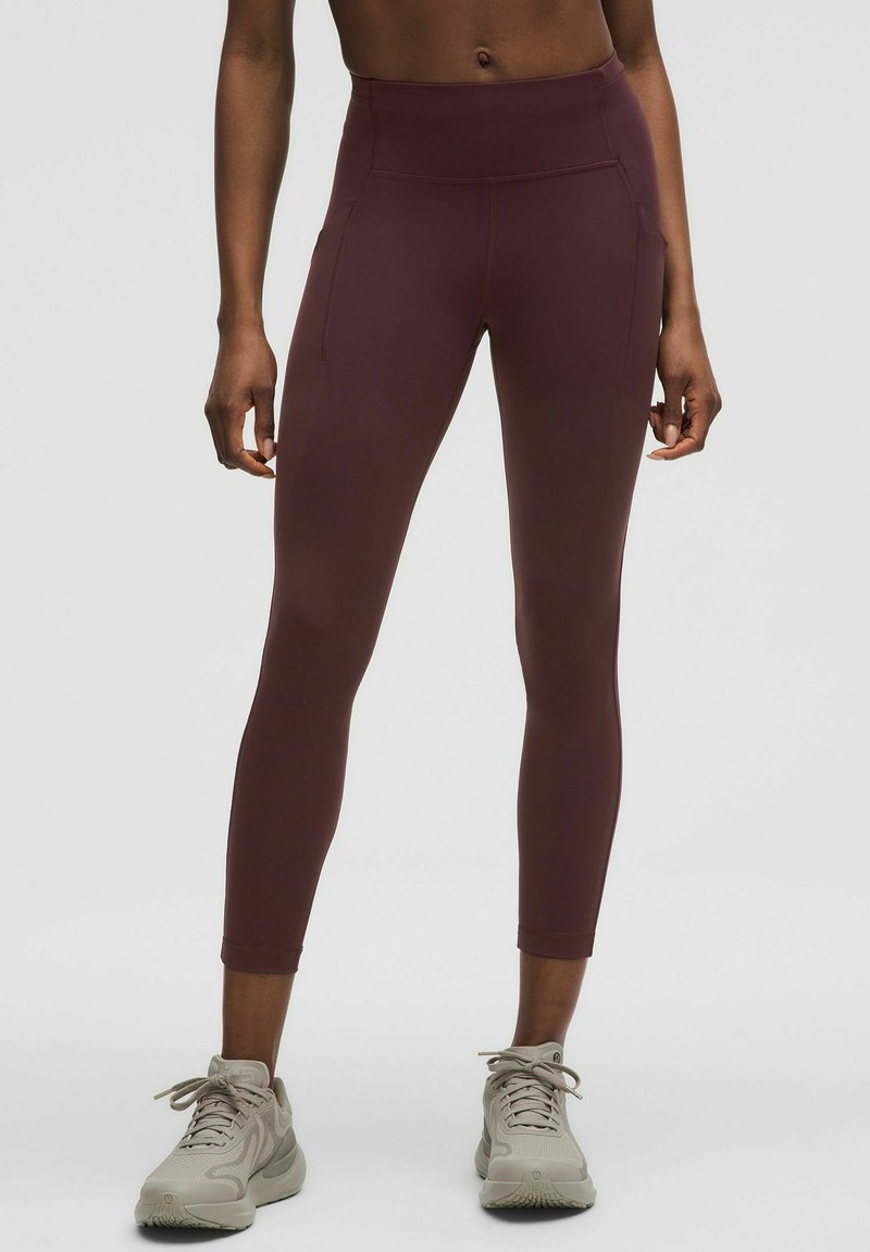 Bordó, magas derekú leggings rugalmas anyagból, oldalsó zsebekkel és az ankle-ig érő, testhez simuló fazonnal.