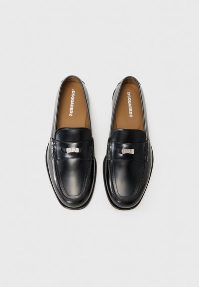 Black leather loafers with a smooth finish, featuring a prominent silver-tone hardware accent and sleek stitching details on the front.