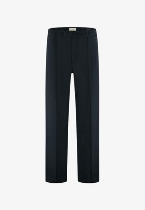 Schwarze gerade geschnittene Hose mit elastischem Bund und vorderen Falten, im Bund mit dem Etikett "Dstrezzed" versehen.