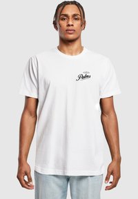 White cotton t-shirt featuring a black printed logo "Palms" on the left chest. Short sleeves and a classic crew neck design.