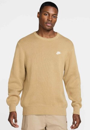 Light brown knit sweater with a classic round neckline. Features ribbed cuffs and hem, and a small white Nike logo on the chest.