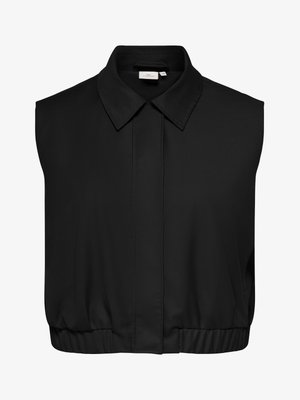 Blouse noire sans manches avec col pointu, boutons avant dissimulés et ourlet élastique, taille 46.