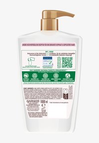 Bottiglia di plastica trasparente con dispenser a pompa marrone, contenente 1000 ml di prodotto per la cura dei capelli. Etichette in tedesco con elenco degli ingredienti e icone di sostenibilità.