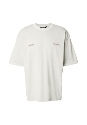 Hvit bomulls-T-skjorte med avslappet passform, ribbet rund hals og subtile broderte detaljer foran. Korte ermer og rett nederkant.