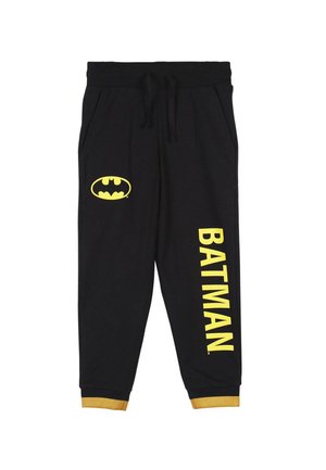Joggers de algodón negros con texto y logo amarillo de "BATMAN". Presenta una cintura elástica, cordón ajustable y puños amarillos. Dos bolsillos laterales.