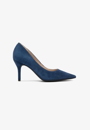 Navy blue suede high-heeled pump with a pointed toe, smooth texture, and a slim stiletto heel, featuring a nude interior lining.