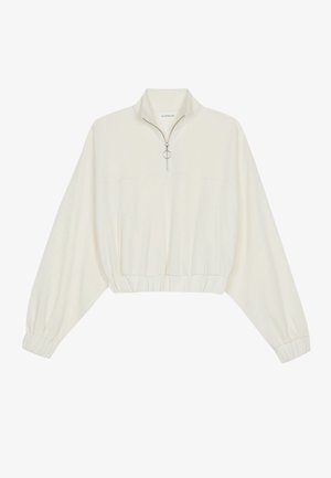 Langärmeliger, offwhite Crop-Pullover mit elastischen Bündchen und Saum, Halb-Reißverschluss mit rundem Metall-Zipper am Stehkragen.