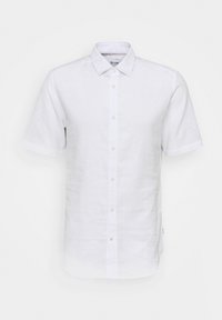 Camicia in lino bianca a maniche corte con bottone frontale, colletto classico e una trama sottile. Presenta una piccola etichetta laterale vicino all'orlo.