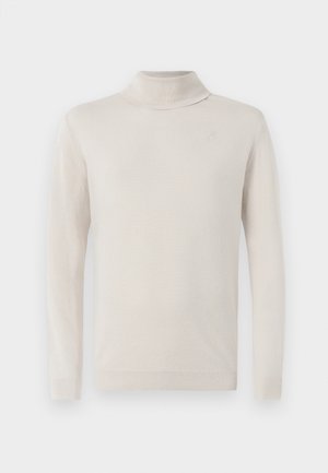 Svetlo bež turtleneck pulover iz mehkega pletenega materiala z dolgimi rokavi. Ima subtilno vezeno logotip blizu izreza.