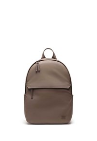 Brown backpack made of smooth, durable material. Features a rounded shape, front flap, zipper, and a top carrying handle. Minimalist design.
