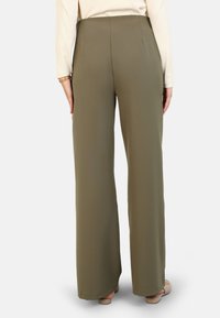 Wide-legged olive green trousers in a smooth fabric with a high waist and two back pockets, featuring a clean, tailored silhouette.