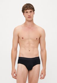 Zwarte katoenen boxershorts met een logo tailleband. Het ontwerp heeft een strakke pasvorm en een soepele textuur, geschik voor dagelijks gebruik.