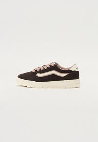 Black suede sneaker with pink laces, curved white stripe, padded collar, and textured sole. Notable features include the Vans logo on the heel.