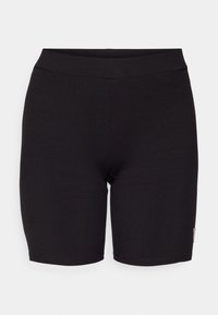 Sorte ribbede sykkeltights med en tettsittende design og en glatt midjebånd. Har diskret søm og en liten logo-merkelapp på siden.