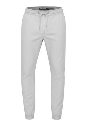 Lys grå joggebukser med elastisk midje, snor og mansjetter ved ankler, designet for komfort og casual bruk.