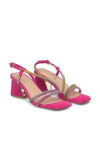 Sandalias de tacón de gamuza rosa con correas en el tobillo metálicas multicolores y punta cuadrada. El tacón ancho aporta estabilidad y brillo al diseño.