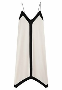 Robe sans manches couleur crème avec un décolleté en V noir et un ourlet assorti, ornée d'accents noirs le long des bords et de fines bretelles.