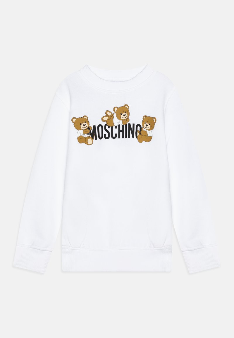 Balta džemperis su trimis animaciniais lokiais ir „MOSCHINO“ užrašu drąsiais juodais rašmenimis. Minkšta medžiaga, įtempti rankogaliai ir apatinė dalis.