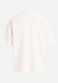 Short-sleeve shirt in light pink with a textured rib pattern, featuring a notched collar and a relaxed fit. Back view displayed.