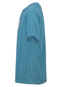 Vaaleansininen lyhythihainen t-paita pyöreällä pääntiellä, valmistettu pehmeästä puuvillasta. Siinä on sivuhalkio ja pieni logopatch etupuolella.