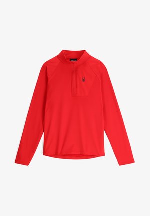 Roter Pullover mit langen Ärmeln und halbem Reißverschluss, der ein strukturiertes Muster aufweist und ein schwarzes Spinnenlogo auf der linken Brustseite hat.