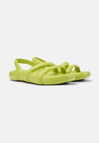 Green rubber sandals featuring a minimalist design with thin straps and open toe. Smooth texture and contoured shape for comfort.