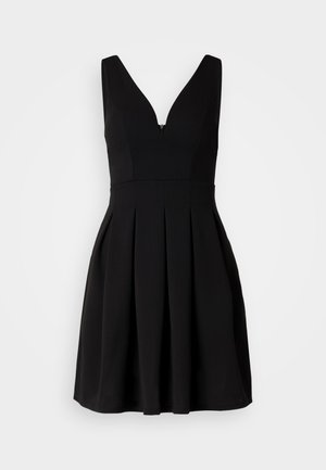 Black dress with a V-neckline and sleeveless design. Features a fitted bodice and pleated skirt. Made from smooth fabric. Hidden zipper closure.