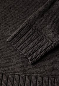 Dark grey knit sweater featuring a ribbed cuff and hem, with a textured weave for warmth and style. Soft fabric with a smooth finish.