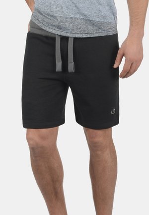 Pantalones cortos de sudor negro hechos de una suave mezcla de algodón, con una cintura elástica ajustable en gris y un logotipo sencillo en el lado inferior.